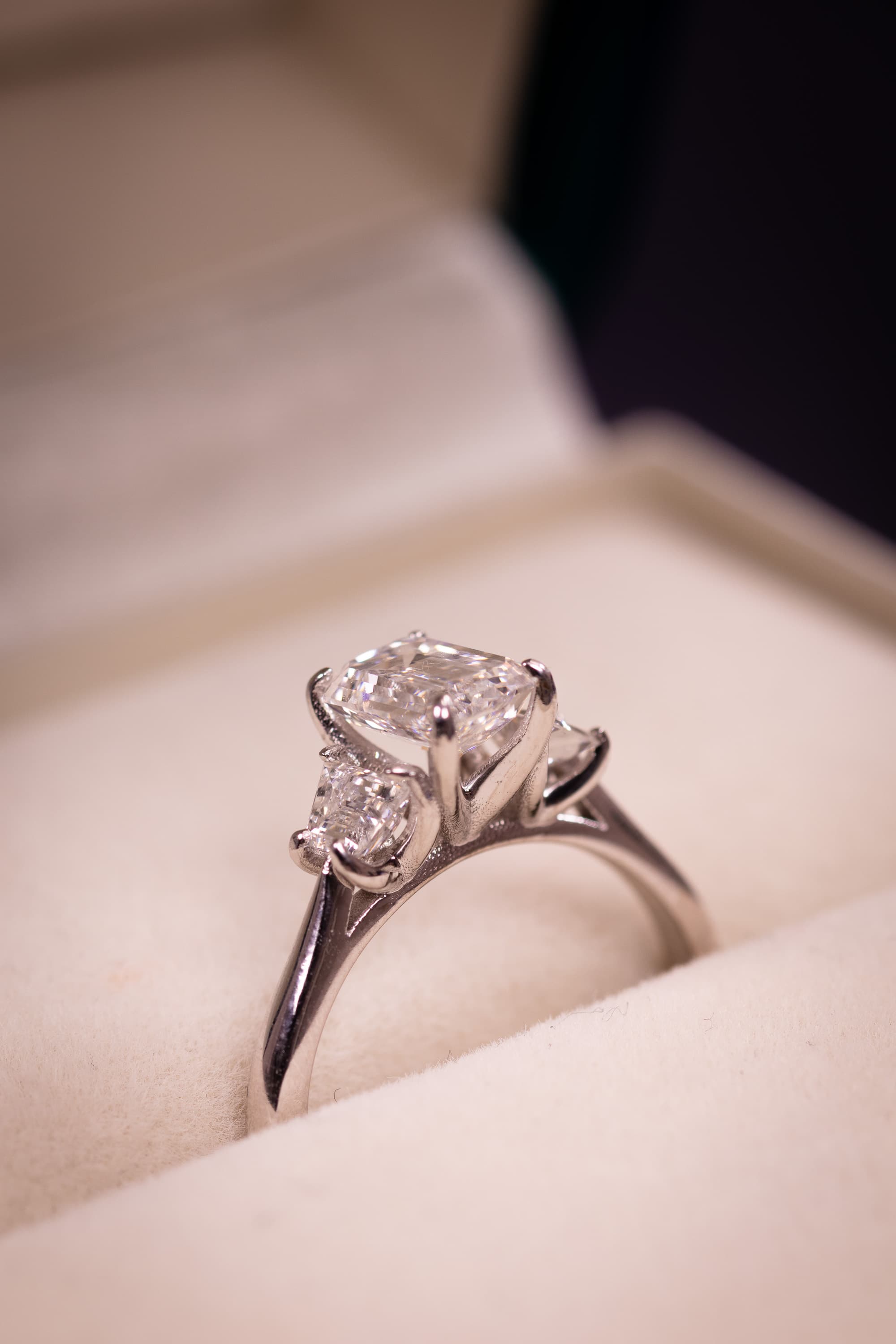 A yellow gold three-stone engagement ring with an oval centre and tapered side stones
