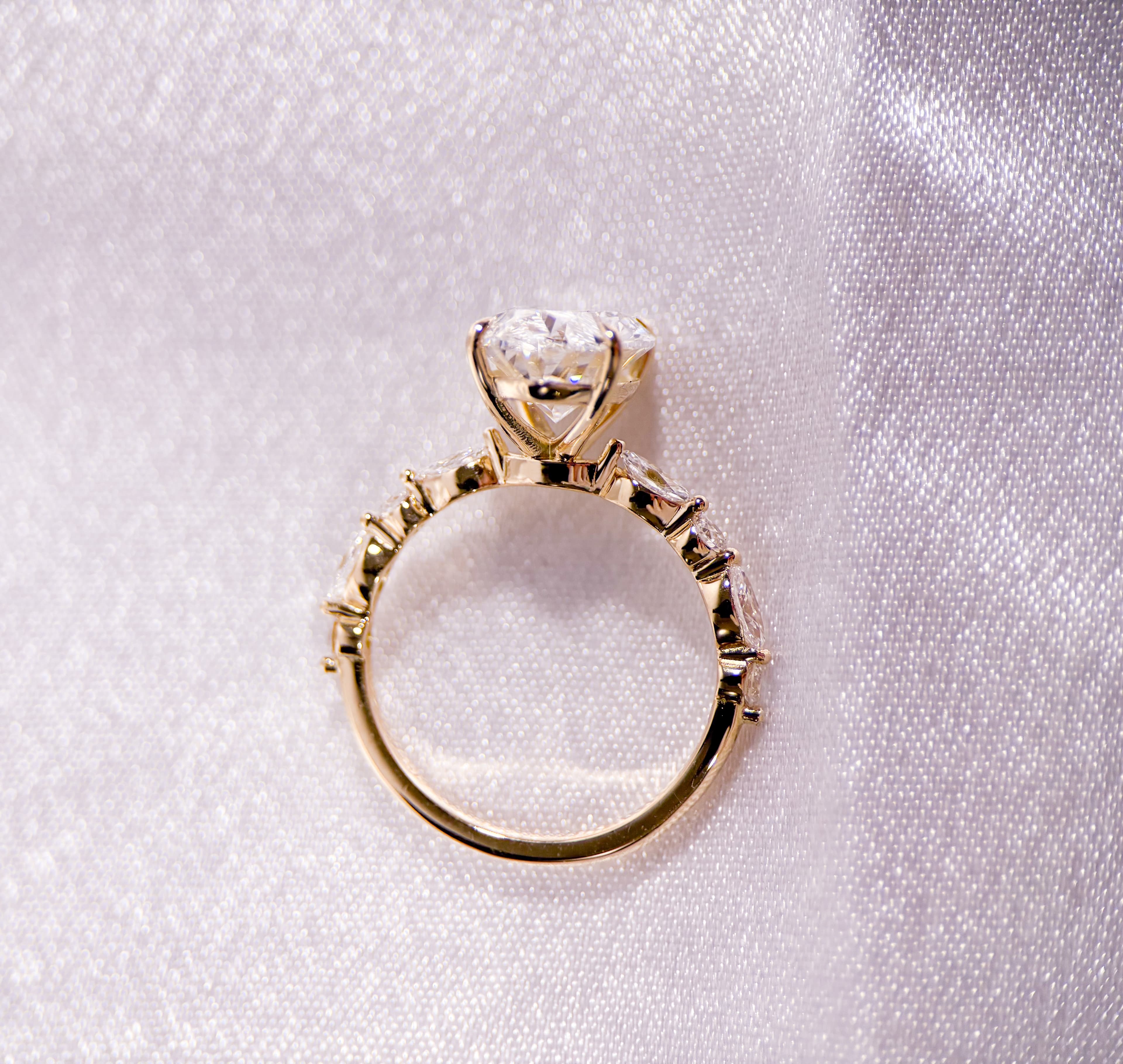 An antique vintage yellow gold engagement ring with milgrain and scrollwork detail