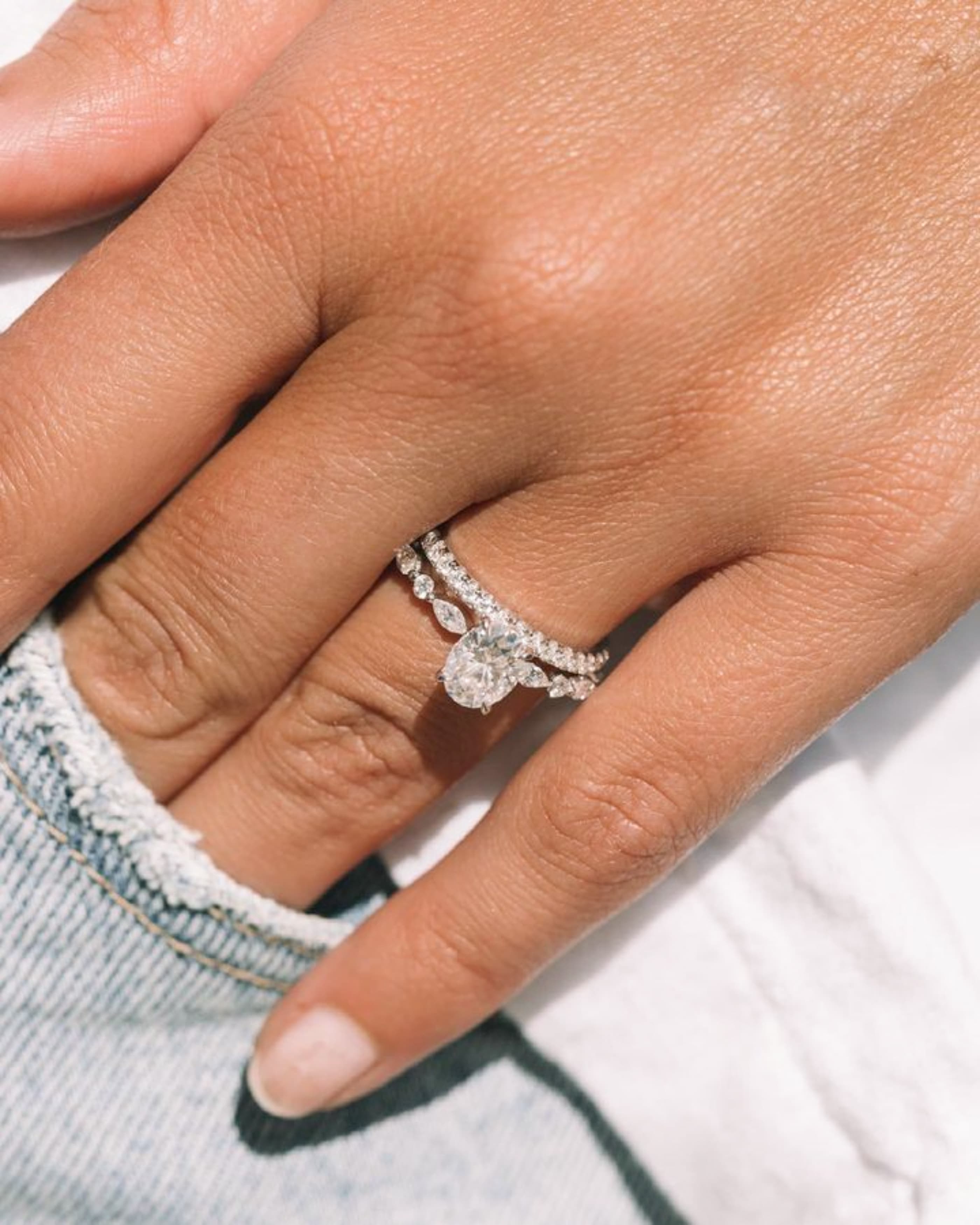 A yellow gold solitaire engagement ring set with a lab-grown oval diamond